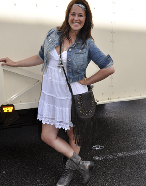 Street style contestant a white boho style shorts dress, military boots and denim jacket